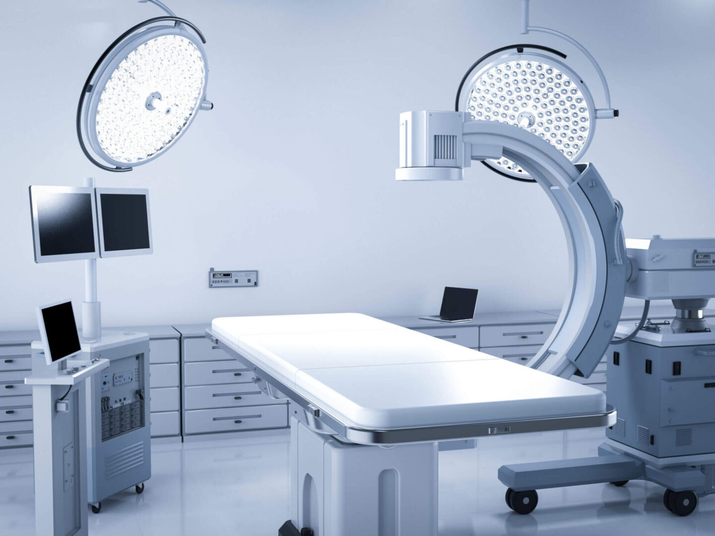 GettyImages-1180686987-copy A hospital room with two operating lights and a table.