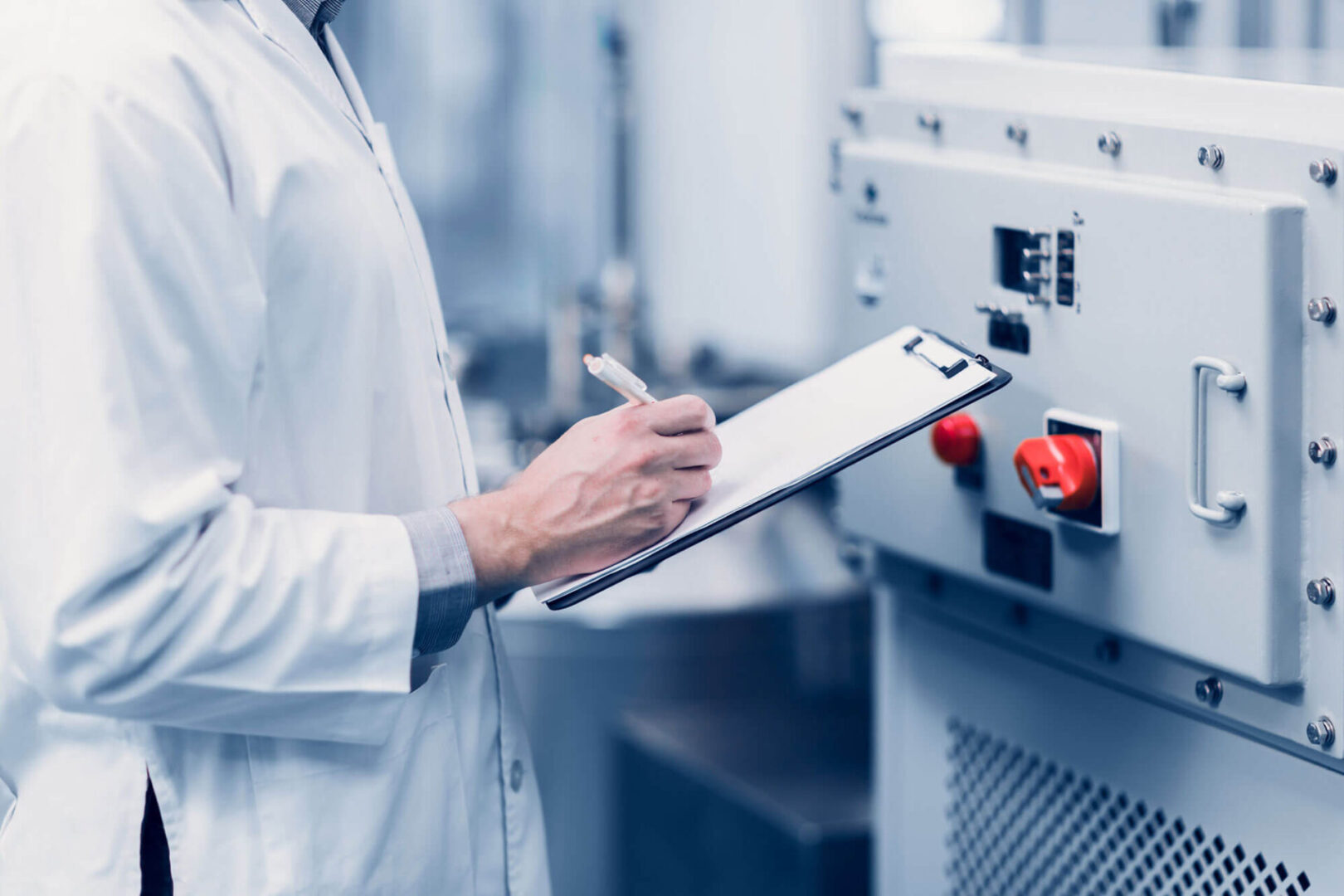 GettyImages-2158689545-copy A person in white lab coat holding a clipboard.
